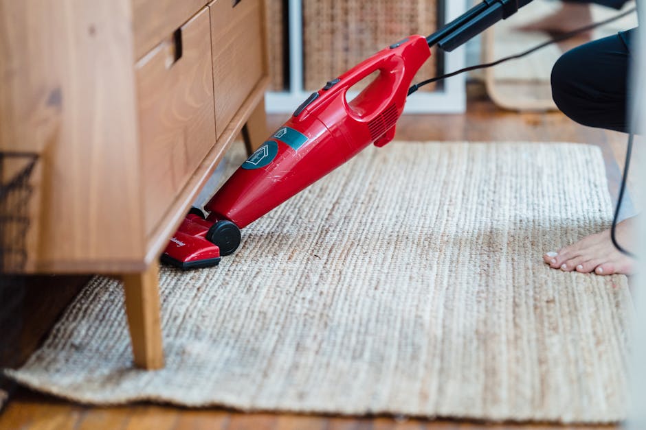 Professional cleaner carefully vacuuming a hardwood floor