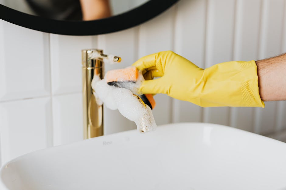 Thorough cleaning of a modern bathroom sink and mirror